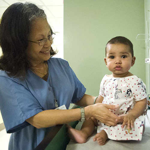 Medical assistant Grace Au with male infant patient