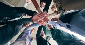 A group of businessmen holding hands together to symbolize unity and strength